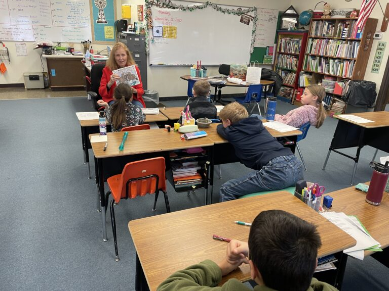 Joan reading to students at Atall school